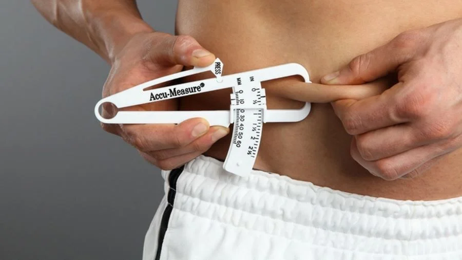 Body fat caliper measurement showing 15mm reading